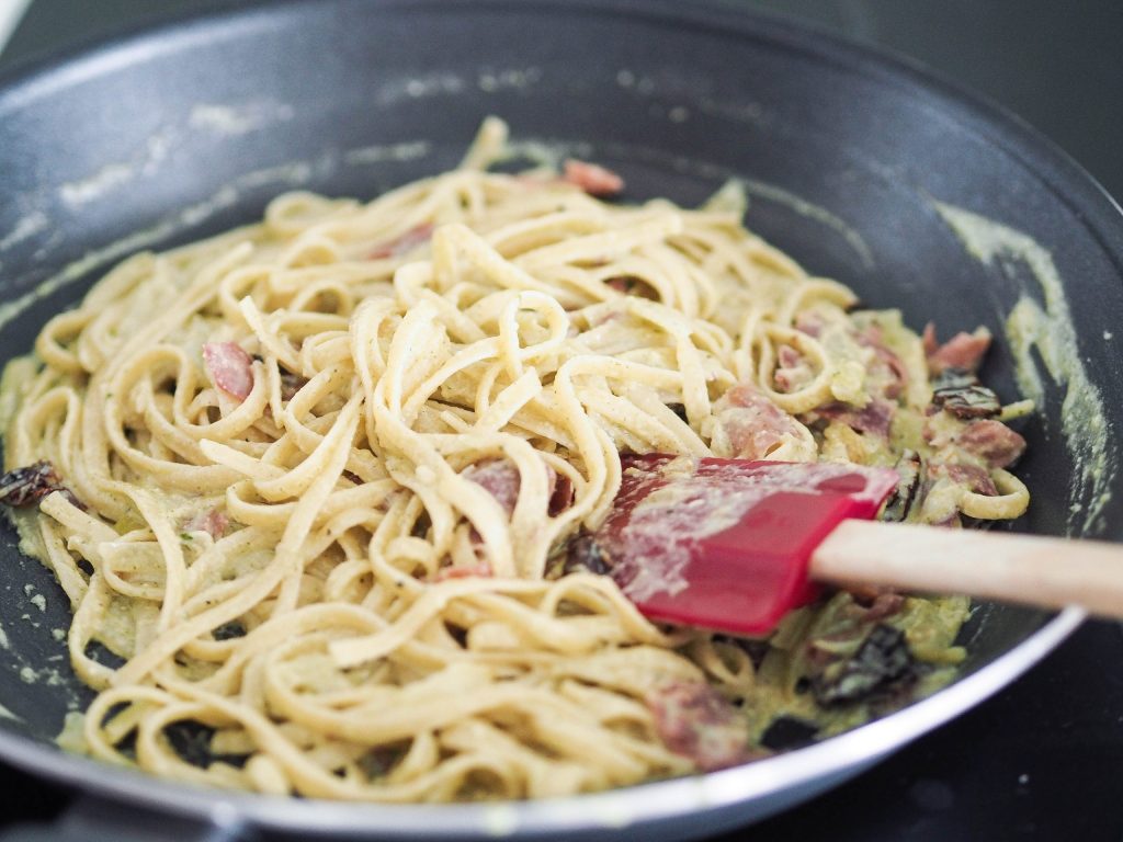 mixed pesto pasta in a pan